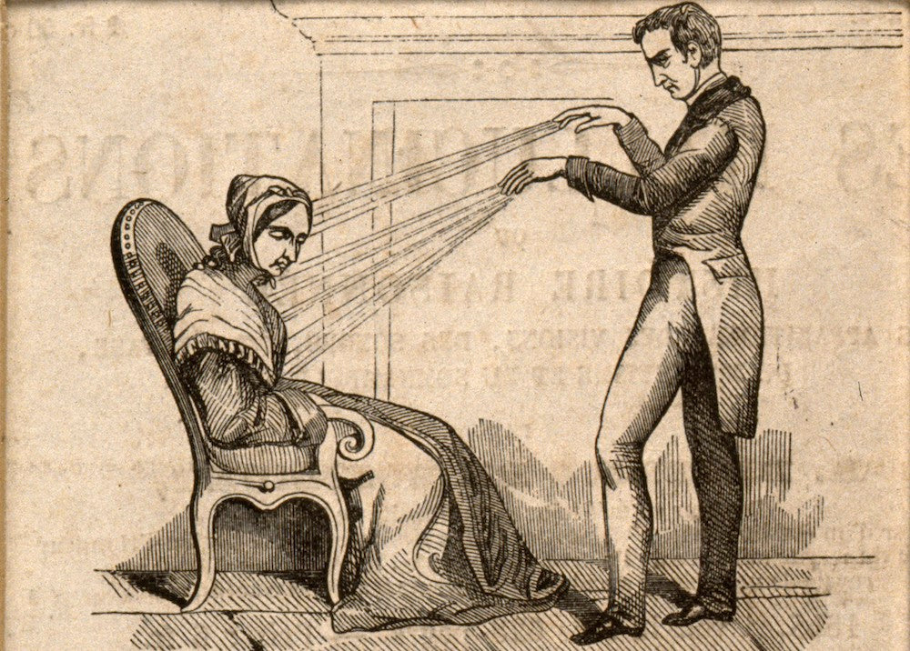 Historical illustration of a practitioner demonstrating animal magnetism